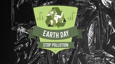 Animation-of-earth-day-text-and-recycling-icon-over-black-plastic