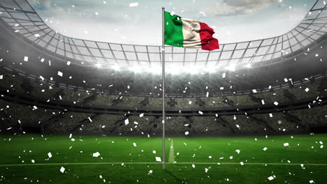 Animation-Von-Konfetti,-Das-über-Die-Wehende-Italienische-Flagge-Vor-Einem-Sportstadion-Fällt