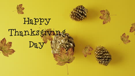 Animation-of-happy-thanksgiving-day-text,-leaves-and-pine-cones-on-yellow-background