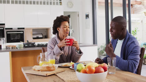 Video-of-happy-african-american-couple-eating-breakfast-together