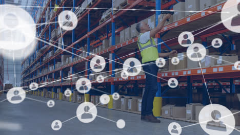 Animation-of-network-of-profile-icons-over-caucasian-male-worker-checking-stock-at-warehouse