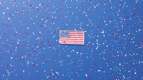Animation-of-confetti-falling-over-flag-of-united-states-of-america-on-blue-background