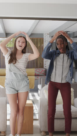 Vertical-video-of-happy-diverse-teenage-female-friends-making-video-blog-in-slow-motion