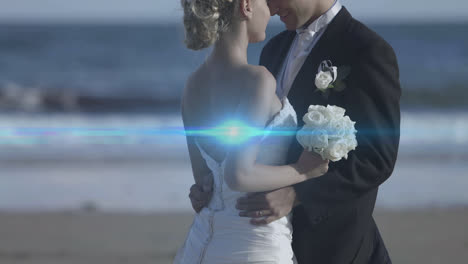 Animation-of-light-moving-over-happy-caucasian-newly-married-couple-on-beach