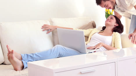 Pretty-woman-using-laptop-on-couch