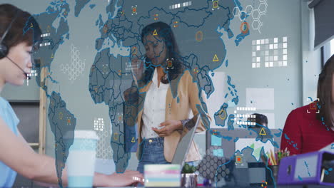 Animation-of-world-map-against-african-american-businesswoman-talking-on-smartphone-at-office