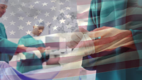 Animation-of-waving-usa-flag-against-mid-section-of-a-surgeon-wearing-surgical-gloves-at-hospital