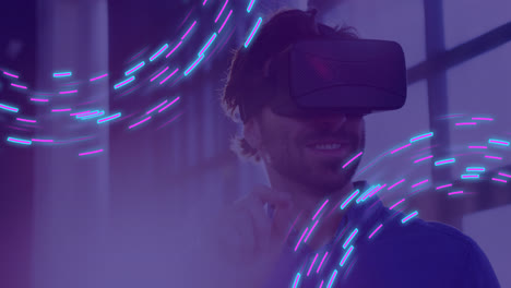 Animation-of-glowing-light-trails-of-data-transfer-and-caucasian-man-in-vr-headset