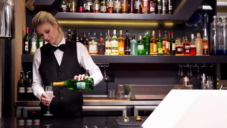 Attractive-blonde-pouring-champagne-at-the-bar