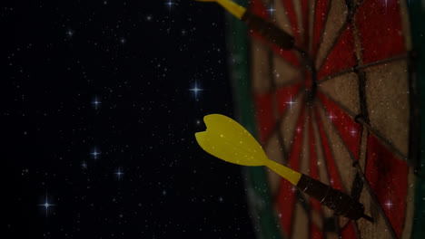 Animation-Von-Leuchtenden-Sternen,-Die-über-Einer-Nahaufnahme-Eines-Gelben-Pfeils-Auf-Einer-Dartscheibe-Schweben