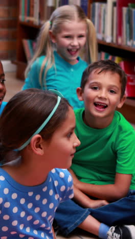 Vertical-video-of-diverse-children-enjoying-a-storytime-at-school