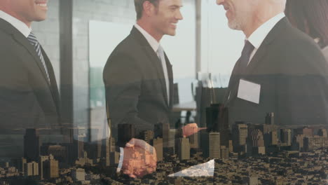 Composite-video-of-two-diverse-businessmen-shaking-hands-against-aerial-view-of-cityscape