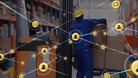 Animation-of-network-of-connections-with-icons-over-caucasian-man-working-in-warehouse
