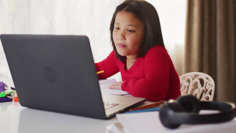 Video-of-happy-asian-girl-having-online-lessons
