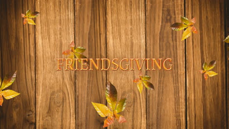 Animation-of-friendsgiving-text-and-autumn-leaves-on-wooden-background