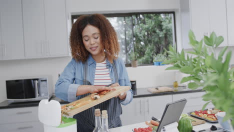 Young-African-American-woman-prepares-a-meal-in-a-modern-kitchen