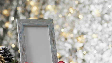 Video-of-christmas-decorations-and-white-frame-with-copy-space-on-fairy-lights-background