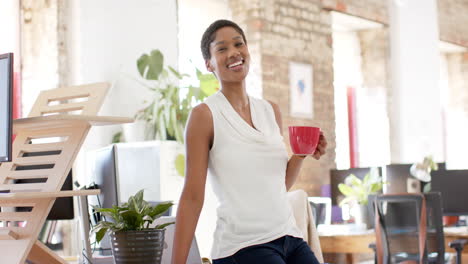 Young-African-American-businesswoman-enjoys-a-coffee-break-at-the-office