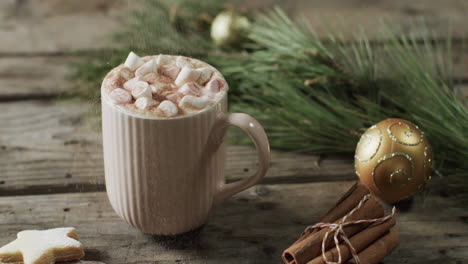 Video-of-mug-of-christmas-chocolate-with-marshmallows-and-copy-space-on-wooden-background