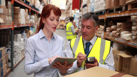 Warehouse-manager-and-boss-using-a-touchscreen-device