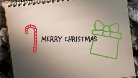 Animation-of-hand-drawing-merry-christmas-and-christmas-decorations-on-white-paper-background