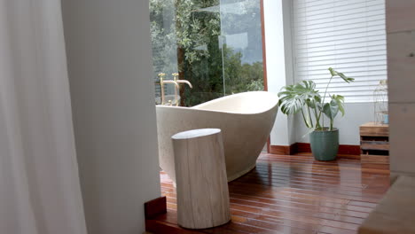 General-view-of-bathroom-with-bathtub-and-window,-slow-motion