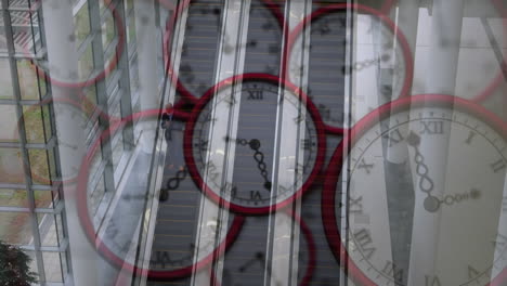 Animation-of-multiple-ticking-clocks-against-aerial-view-of-escalators-at-modern-office