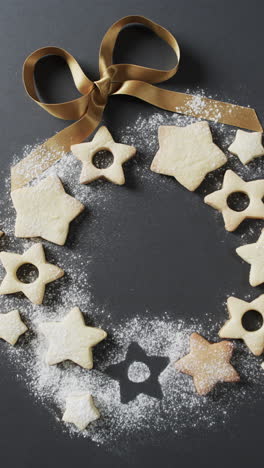 Vertical-video-of-star-christmas-cookies-with-sugar-and-copy-space-on-black-background