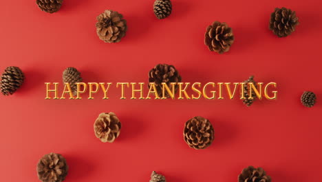 Animation-of-happy-thanksgiving-text-and-pine-cones-on-red-background