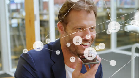 Animation-of-network-of-connections-with-icons-over-caucasian-businessman-talking-on-smartphone