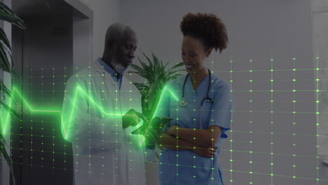 Animation-of-heart-rate-monitor-over-diverse-male-doctor-and-healthworker-discussing-at-hospital