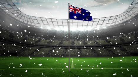 Animation-Von-Konfetti,-Das-über-Die-Wehende-Australische-Flagge-Vor-Einem-Sportstadion-Fällt
