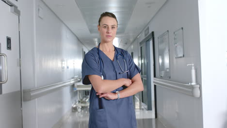 Confident-Caucasian-woman-doctor-stands-in-a-hospital-corridor