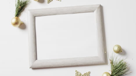 Video-of-christmas-decorations-and-white-frame-with-copy-space-on-white-background