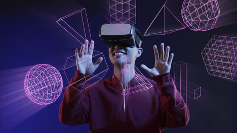 Animation-of-glowing-3d-shapes-over-asian-man-using-vr-headset