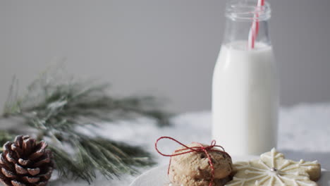Video-of-christma-cookies,-bottle-of-milk-and-copy-space-on-white-background