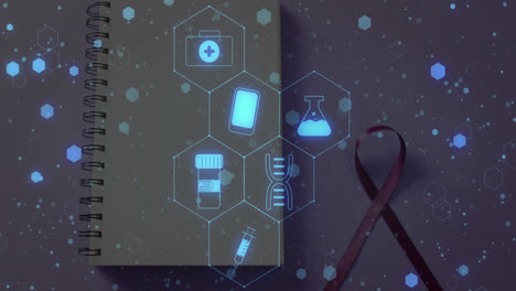 Animation-of-medical-icons-over-notebook-and-ribbon