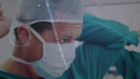Network-of-connections-over-close-up-of-caucasian-male-surgeon-wearing-surgical-mask-at-hospital