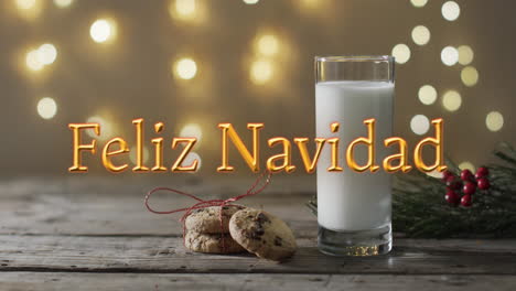 Feliz-navidad-text-in-orange-over-christmas-cookies-and-milk-and-bokeh-lights-background