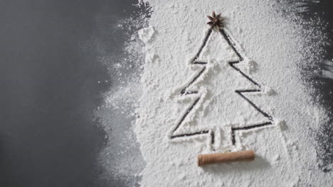 Video-of-christmas-tree-drawn-in-flour-and-copy-space-on-black-background