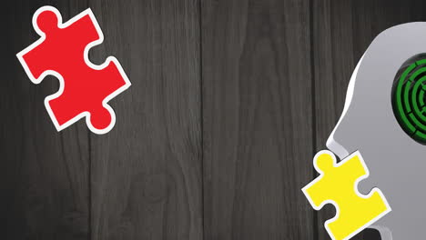 Animation-of-multi-coloured-puzzle-pieces-over-wooden-background