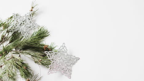 Video-of-fir-tree-branches-christmas-decorations-with-copy-space-on-white-background