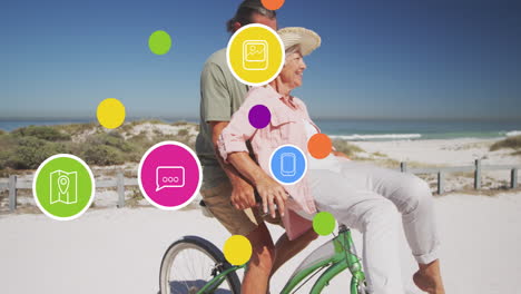 Animation-of-social-media-text-and-icons-over-caucasian-couple-riding-bike-on-beach