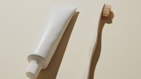 Close-up-of-toothbrush-and-toothpaste-on-beige-background