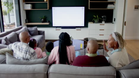 African-american-parents,-son,-daughter-and-grandparents-watching-tv-with-copy-space,-slow-motion