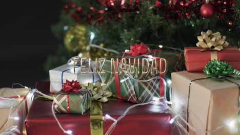 Feliz-navidad-text-over-christmas-gifts,-lights-and-tree