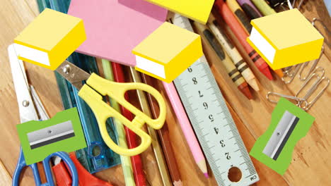 A-variety-of-school-supplies-are-scattered-on-a-wooden-surface