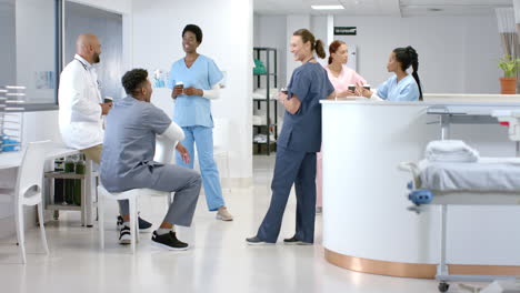 Diverse-healthcare-professionals-converse-in-a-hospital