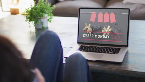 Woman-at-table-using-laptop,-online-shopping-on-cyber-monday,-slow-motion