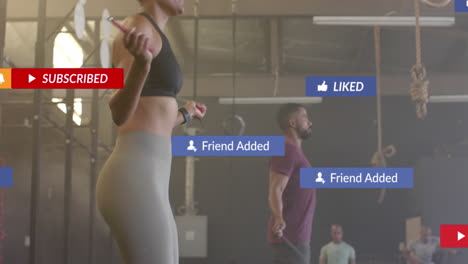 Animation-of-social-media-notifications-over-diverse-woman-and-man-jumping-rope-at-gym